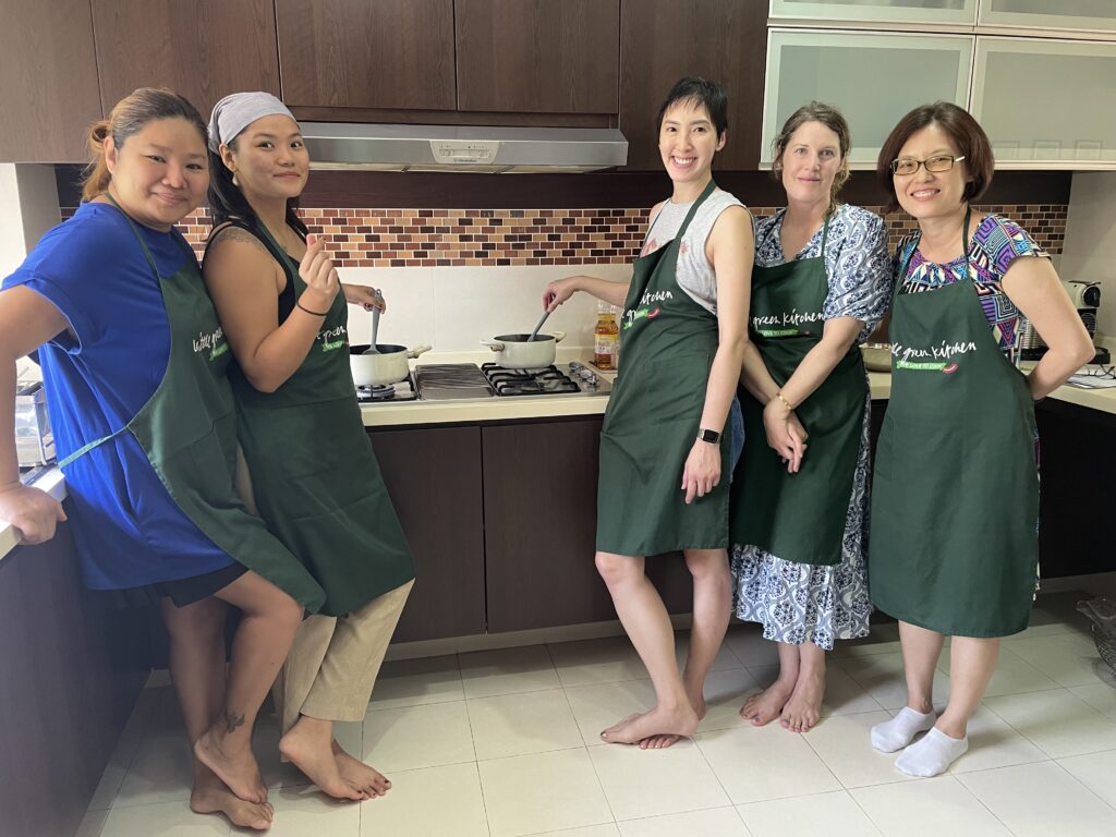 Students chopping vegetables during a Thai vegan cooking class at Little Green Kitchen Singapore